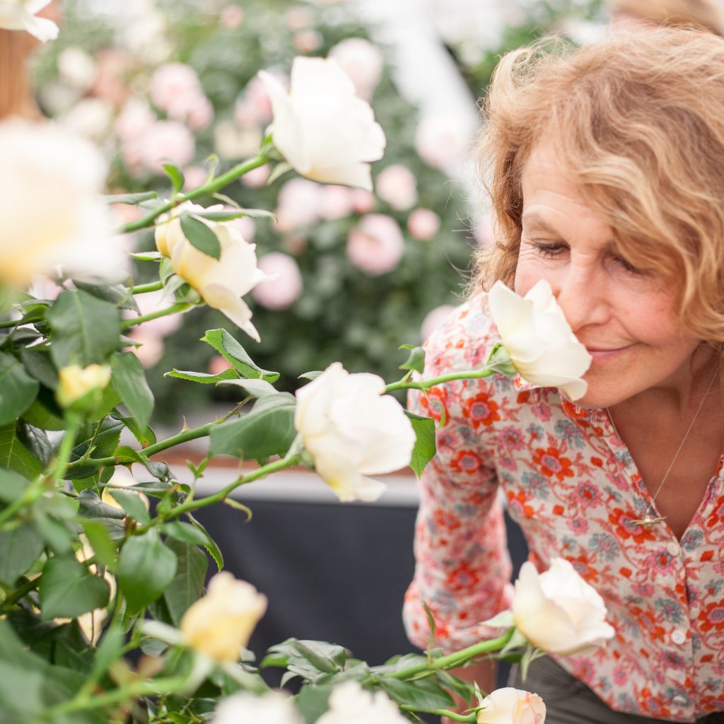 rosebie smelling roses